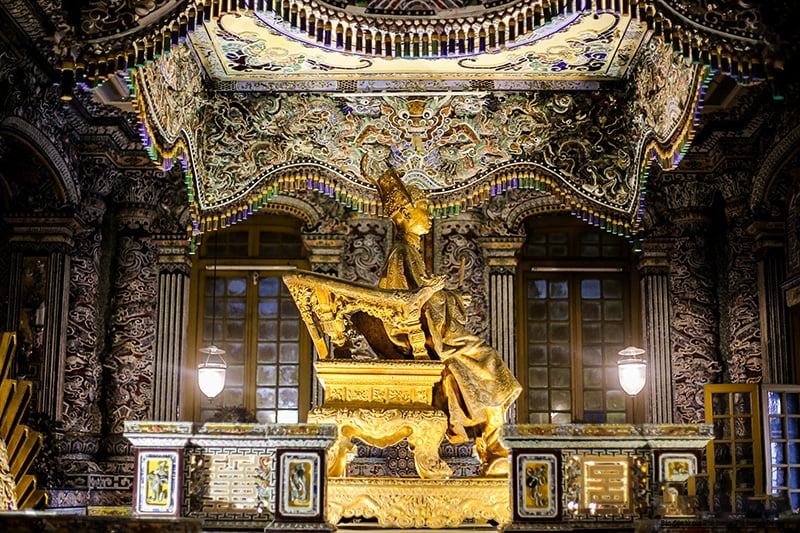 The bronze statue placed on the golden throne in Khai Thanh Palace is gilded with gold