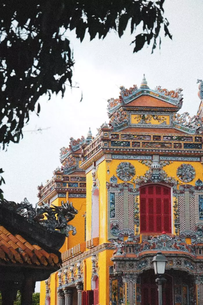 Interior view of Kien Trung Palace displaying royal artifacts, including garments and shoes of the Nguyen Dynasty.