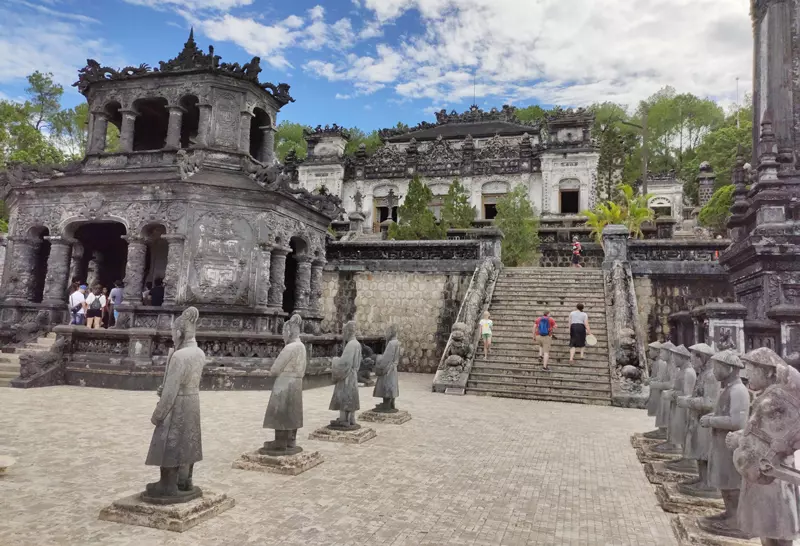 A view of one of the Royal Tombs in Hue, showcasing its unique architecture and tranquil setting.