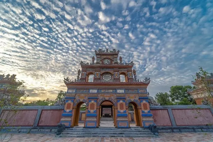 Tomb of Duc Duc in Hue with a tranquil landscape of mountains, stream, and simple surroundings.