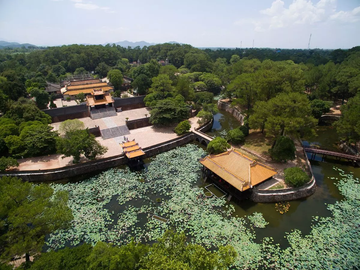 Tomb of Tu Duc in Hue with beautiful natural surroundings, lush greenery, and serene ponds.