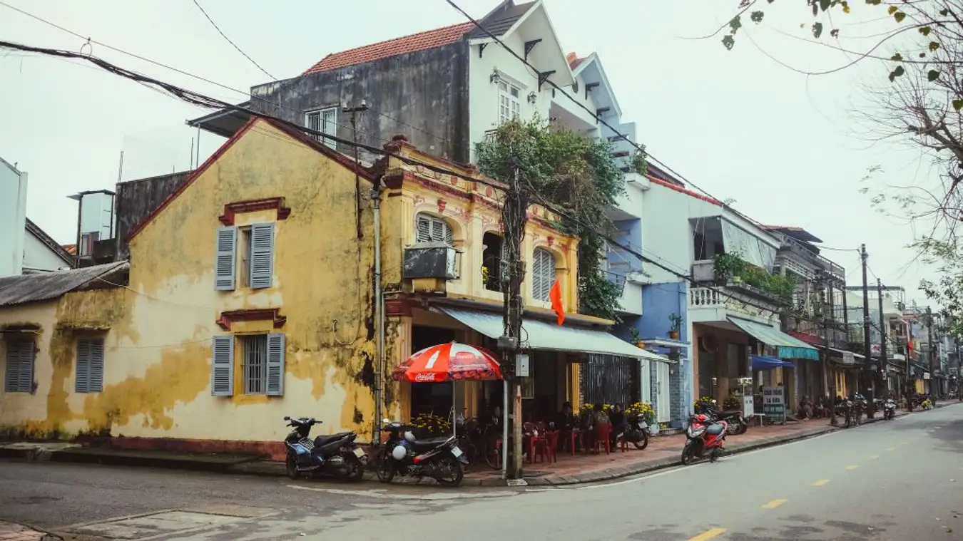 Bao Vinh Ancient Town in Hue, Vietnam, showcasing historic wooden houses with low-tiled roofs and 20th-century modern architecture.