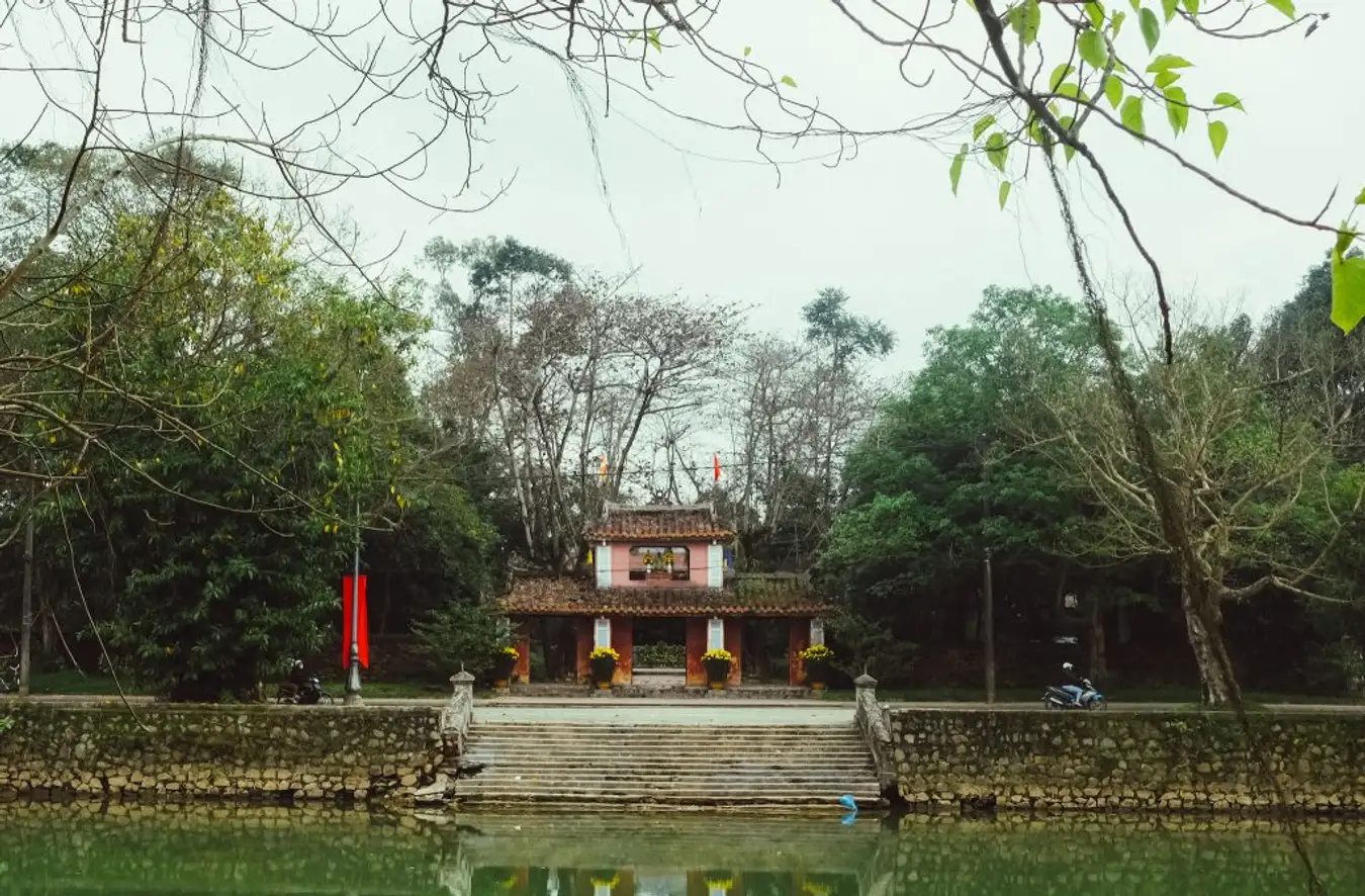 Bao Vinh Ancient Town in Hue, Vietnam, at sunset, showcasing moss-covered houses along the Perfume River.