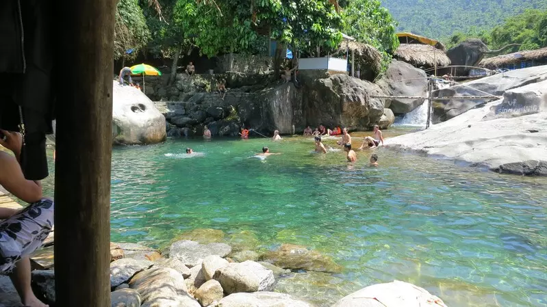 Scenic summer view of Elephant Springs in Hue with lush greenery, clear water, and a peaceful landscape, perfect for relaxation.