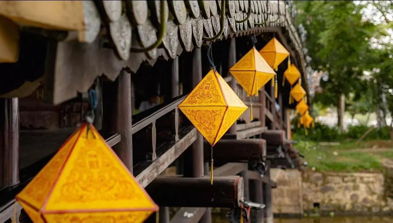 Thanh Toan Tile-Roofed Bridge, a historic wooden arched bridge with a tiled roof in Hue, Vietnam, spanning a canal in Thanh Thuy Chanh Village.